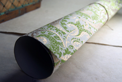 cream with green and gold handmade paper rolled